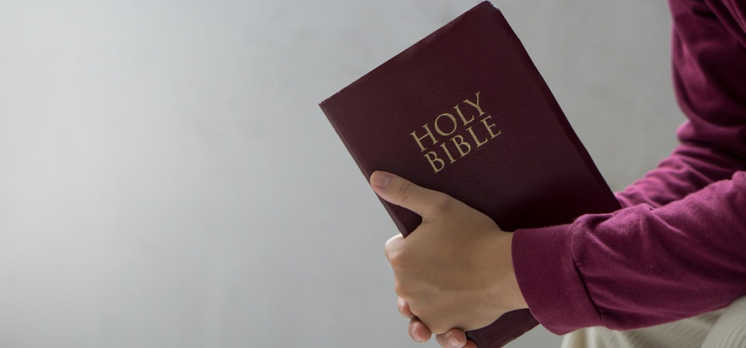 Bible concept.Man reading bible and praying to god before work.
